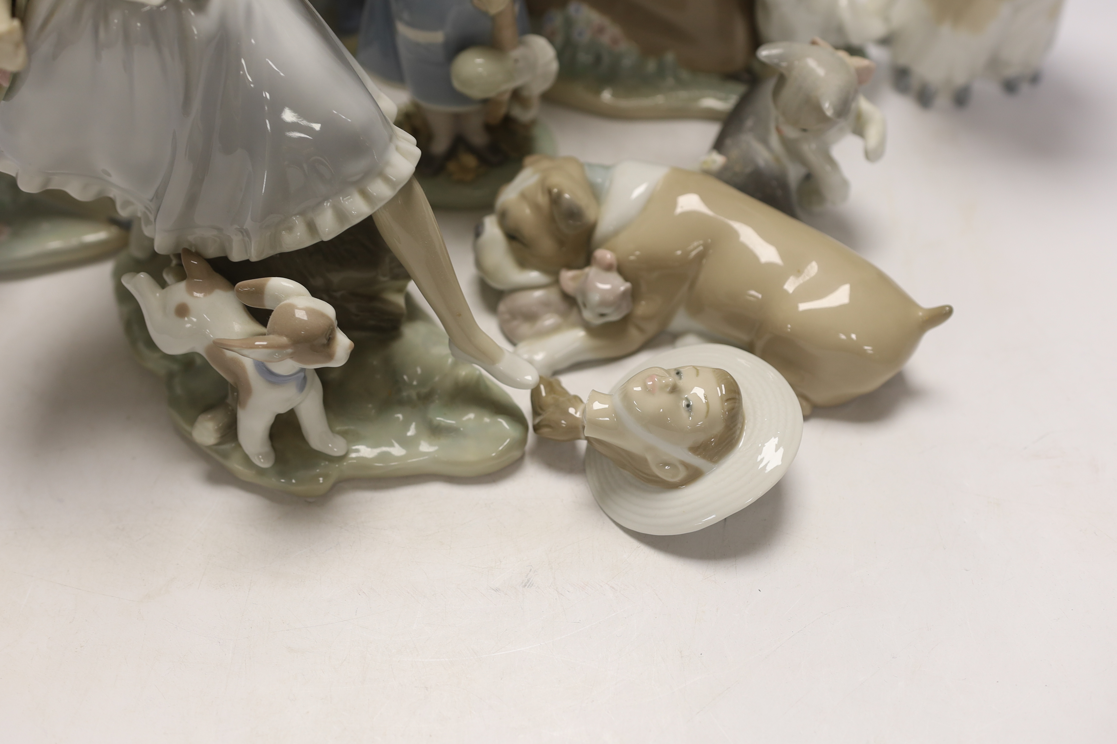 Ten Lladro and Nao figures including a short eared owl and a girl with braids, largest 26cm high